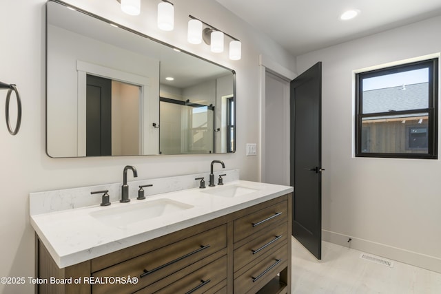 656 Stone Peak Loop, Driggs, ID 83422 - bathroom with visible vents, a sink, a shower with shower door, and double vanity