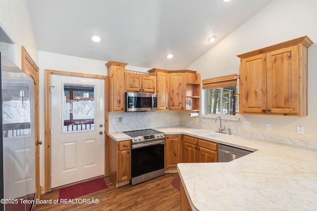 kitchen with open shelves, light countertops, a sink, and stainless steel appliances