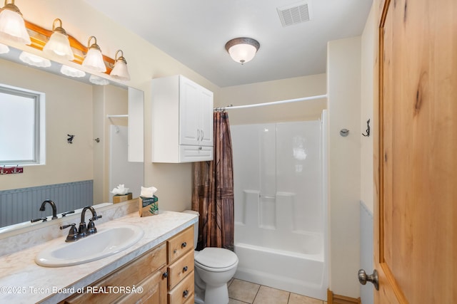 bathroom featuring tile patterned floors, toilet, vanity, shower / tub combo, and visible vents
