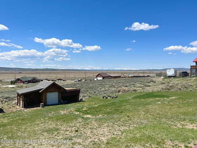 25 Vixen Cir, Pinedale, WY 82941 - view of grassy yard featuring a view of rural / pastoral area and an outdoor structure