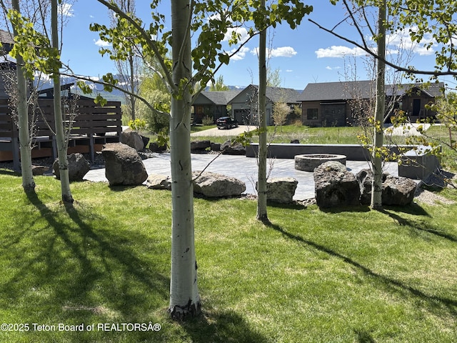 398 Palisade Trl, Driggs, ID 83422 - view of green lawn with a fire pit and a patio
