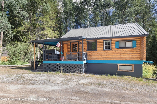 view of front of property with covered porch and metal roof