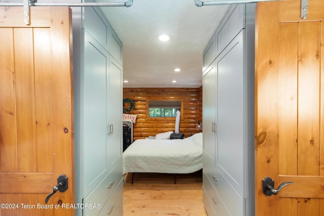 bedroom featuring a textured ceiling, recessed lighting, and hardwood / wood-style flooring