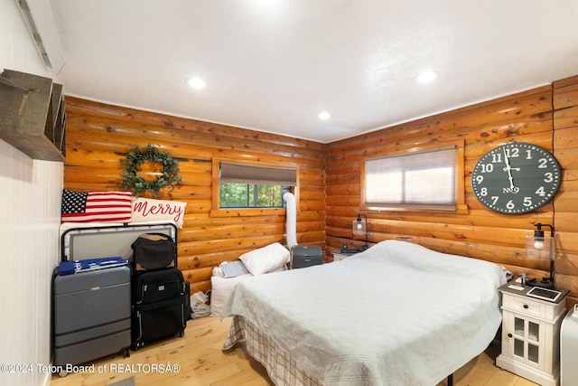 bedroom featuring rustic walls, recessed lighting, and light wood finished floors