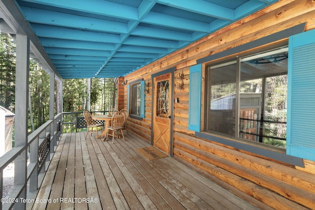 wooden terrace featuring outdoor dining area