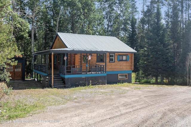 view of front of house featuring metal roof, covered porch, and a standing seam roof
