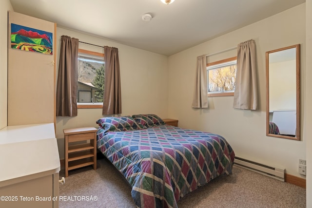 bedroom featuring baseboard heating, carpet, and multiple windows