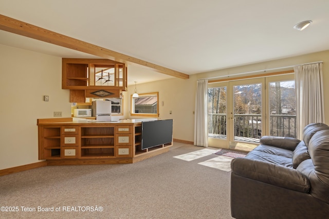 living room with baseboards, light carpet, and beam ceiling