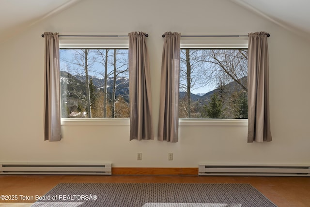 bonus room featuring baseboard heating and vaulted ceiling