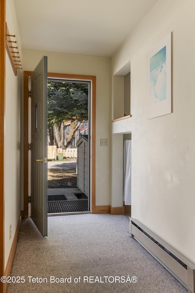 entryway with baseboard heating and carpet flooring