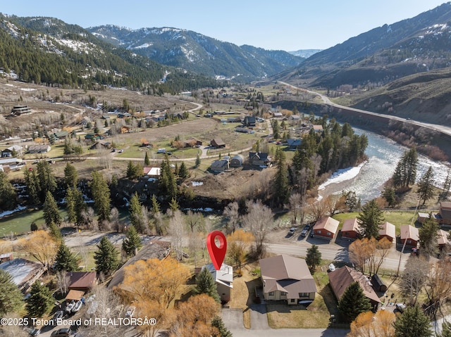 view of property location with a mountain backdrop and nearby suburban area
