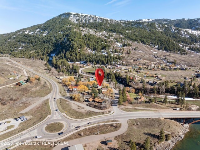 aerial view of property and surrounding area with mountains