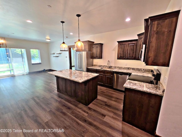 8531 Caribou Ct, Victor, ID 83455 - kitchen with stainless steel appliances, dark brown cabinetry, dark wood-type flooring, a kitchen island, and a sink
