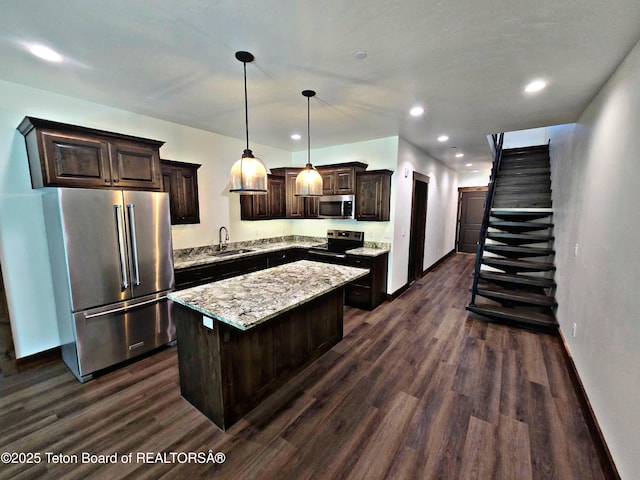 8531 Caribou Ct, Victor, ID 83455 - kitchen featuring appliances with stainless steel finishes, a sink, dark wood-style floors, dark brown cabinetry, and baseboards
