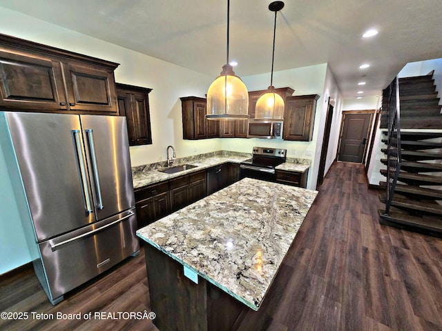 8531 Caribou Ct, Victor, ID 83455 - kitchen with appliances with stainless steel finishes, a sink, dark brown cabinetry, dark wood-style flooring, and recessed lighting