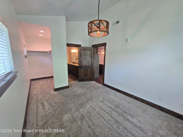 8531 Caribou Ct, Victor, ID 83455 - spare room featuring carpet floors, baseboards, and a towering ceiling