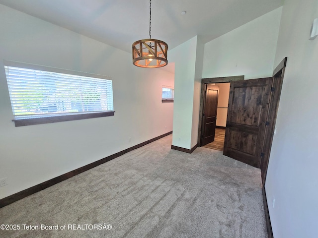 8531 Caribou Ct, Victor, ID 83455 - carpeted empty room featuring baseboards and vaulted ceiling