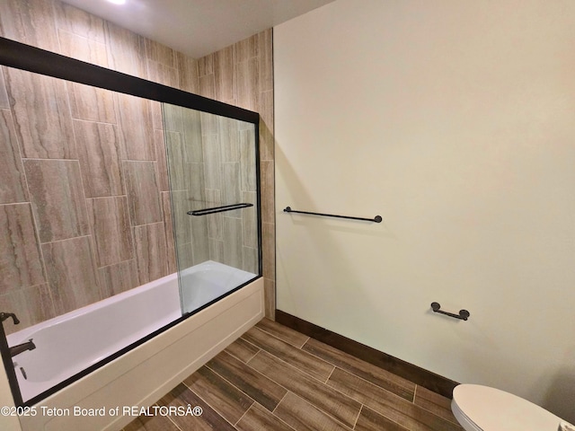 8531 Caribou Ct, Victor, ID 83455 - bathroom with toilet, bath / shower combo with glass door, baseboards, and wood tiled floors