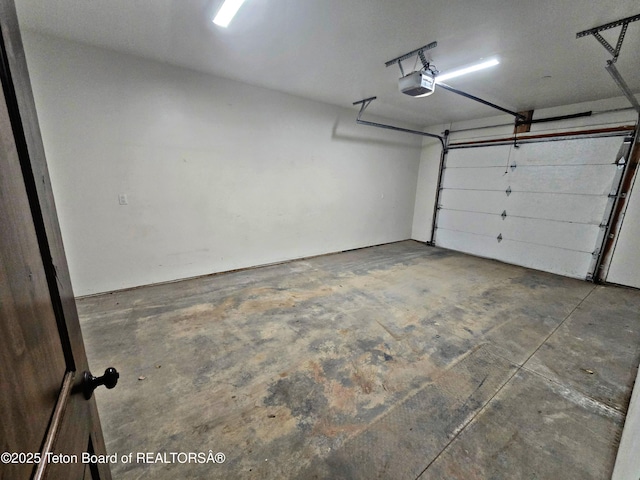 8531 Caribou Ct, Victor, ID 83455 - garage featuring a garage door opener