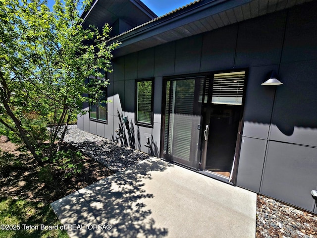 8531 Caribou Ct, Victor, ID 83455 - doorway to property with board and batten siding and a patio