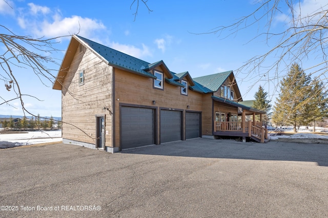 980 S 1000 E, Driggs, ID 83455 - view of side of home featuring metal roof, an attached garage, and driveway