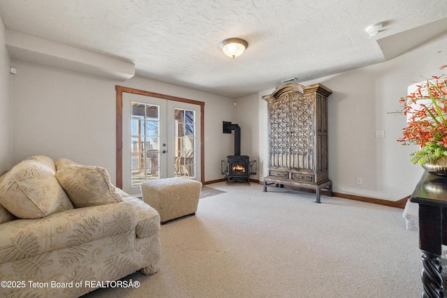 980 S 1000 E, Driggs, ID 83455 - living area featuring a wood stove, french doors, carpet, baseboards, and a textured ceiling