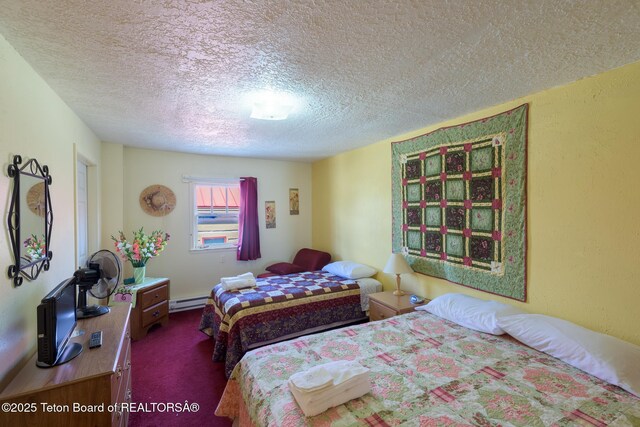 bedroom featuring carpet flooring, a textured ceiling, and a baseboard heating unit