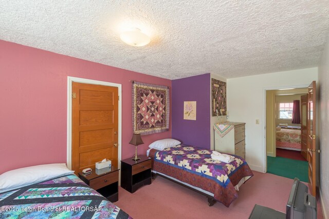 bedroom with a textured ceiling and carpet