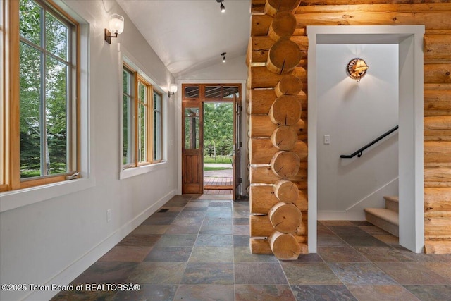 3300 N Trapper Ln, Wilson, WY 83014 - foyer entrance featuring rustic walls, stone finish flooring, stairway, and lofted ceiling