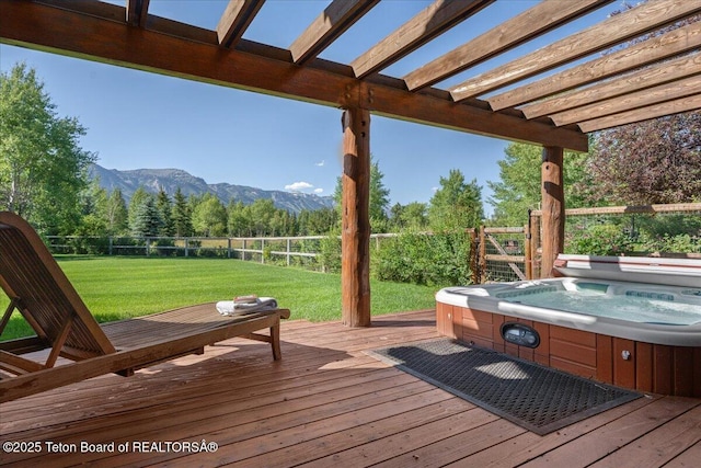3300 N Trapper Ln, Wilson, WY 83014 - deck featuring a hot tub, a mountain view, a fenced backyard, and a pergola