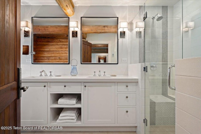 3300 N Trapper Ln, Wilson, WY 83014 - bathroom with double vanity, a shower stall, and decorative backsplash