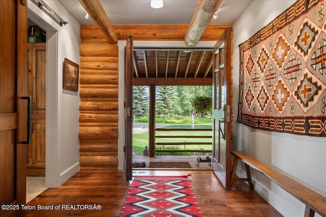 3300 N Trapper Ln, Wilson, WY 83014 - entryway featuring log walls, beamed ceiling, and wood finished floors
