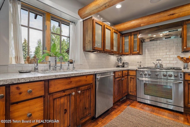 3300 N Trapper Ln, Wilson, WY 83014 - kitchen with stainless steel appliances, backsplash, beamed ceiling, dark wood-style flooring, and brown cabinetry