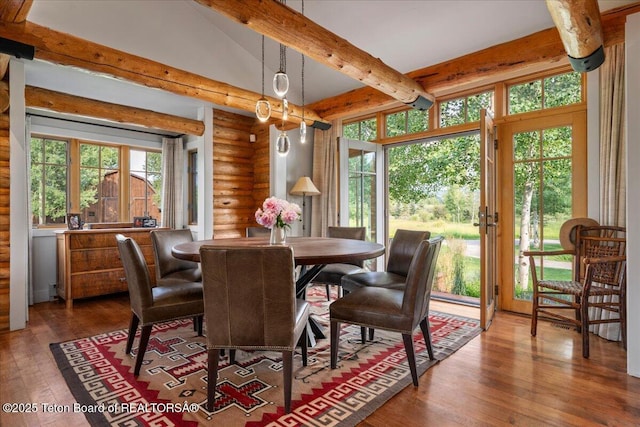3300 N Trapper Ln, Wilson, WY 83014 - dining area with rustic walls, hardwood / wood-style floors, and beam ceiling