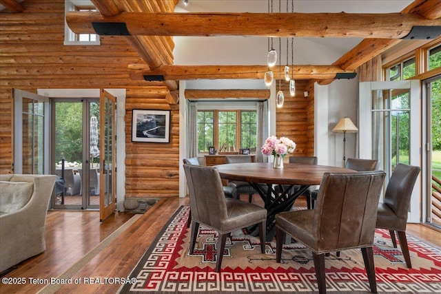 3300 N Trapper Ln, Wilson, WY 83014 - dining room with rustic walls, wood finished floors, beamed ceiling, and healthy amount of natural light
