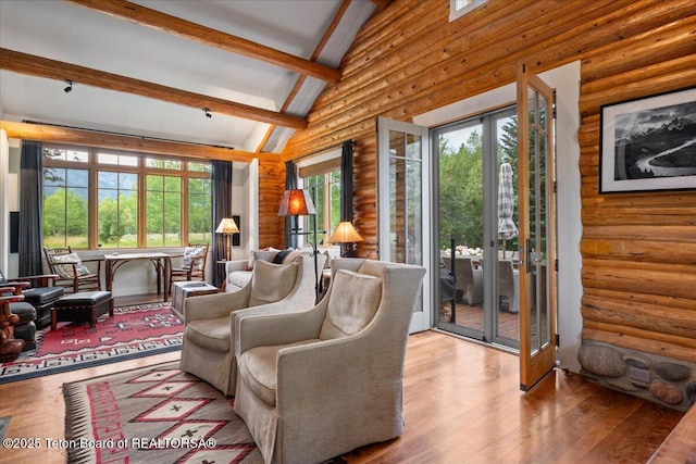3300 N Trapper Ln, Wilson, WY 83014 - living area featuring log walls, wood finished floors, beamed ceiling, and high vaulted ceiling