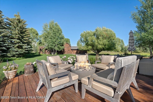 3300 N Trapper Ln, Wilson, WY 83014 - wooden terrace with a lawn and an outdoor living space with a fire pit