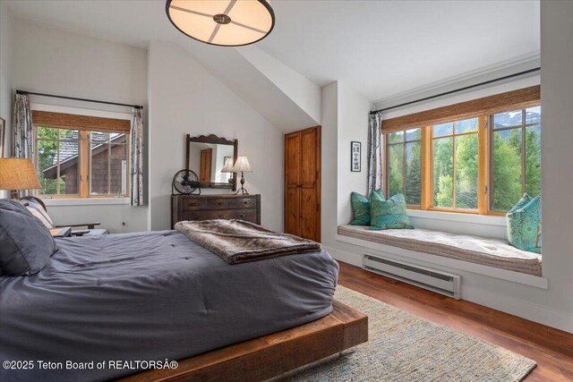 3300 N Trapper Ln, Wilson, WY 83014 - bedroom featuring a baseboard heating unit and wood finished floors