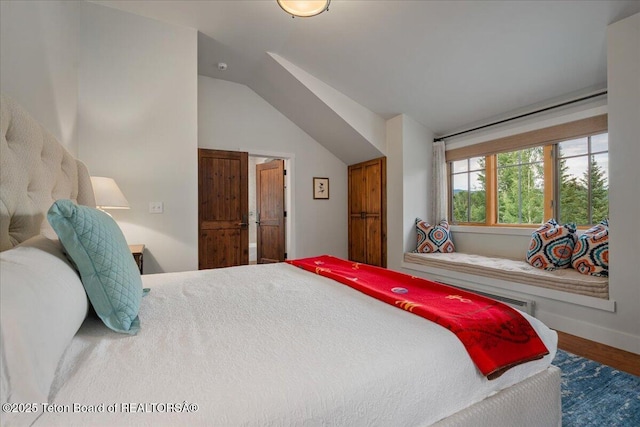 3300 N Trapper Ln, Wilson, WY 83014 - bedroom featuring wood finished floors and lofted ceiling
