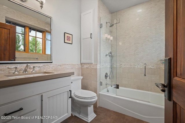3300 N Trapper Ln, Wilson, WY 83014 - bathroom with tile patterned floors, vanity, tile walls, shower / bath combination, and wainscoting