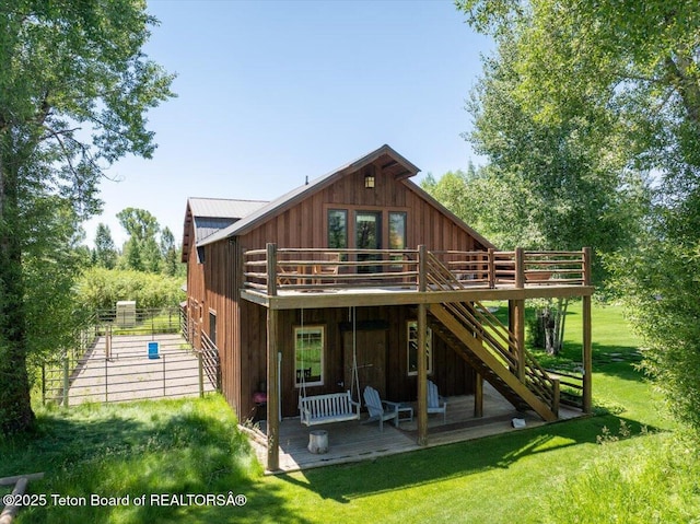 3300 N Trapper Ln, Wilson, WY 83014 - rear view of house featuring stairs, a deck, a yard, board and batten siding, and a metal roof