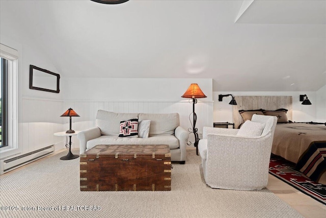 3300 N Trapper Ln, Wilson, WY 83014 - bedroom featuring baseboard heating, lofted ceiling, wood finished floors, and wainscoting