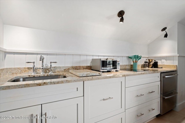 3300 N Trapper Ln, Wilson, WY 83014 - kitchen with white cabinets, light stone counters, lofted ceiling, and dishwasher