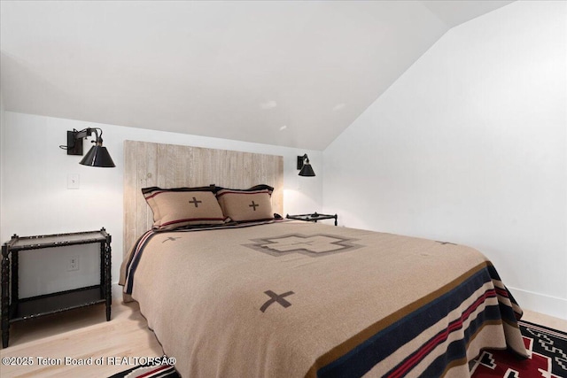 3300 N Trapper Ln, Wilson, WY 83014 - bedroom featuring lofted ceiling and wood finished floors