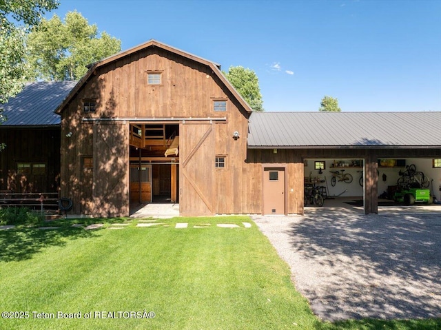 3300 N Trapper Ln, Wilson, WY 83014 - view of front of house with a metal roof, an outdoor structure, an exterior structure, and a gambrel roof
