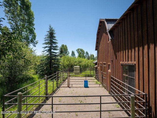 3300 N Trapper Ln, Wilson, WY 83014 - view of property exterior with board and batten siding, an exterior structure, and a metal roof