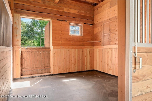 3300 N Trapper Ln, Wilson, WY 83014 - spare room featuring plenty of natural light and wood walls