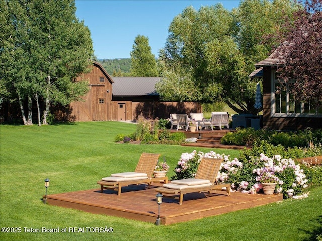 3300 N Trapper Ln, Wilson, WY 83014 - view of grassy yard featuring a wooden deck and a barn