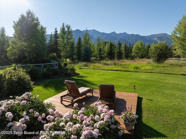 3300 N Trapper Ln, Wilson, WY 83014 - view of grassy yard with a deck with mountain view