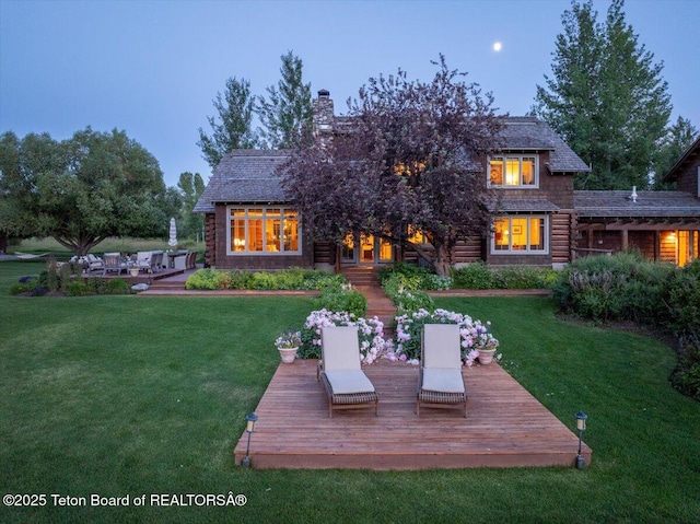 3300 N Trapper Ln, Wilson, WY 83014 - back of property with a lawn, a deck, and a chimney